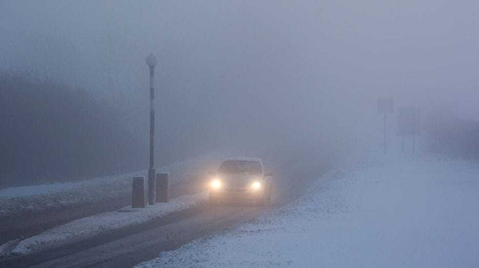 Winter driving car driving in fog